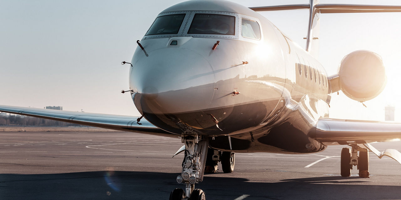 Front angled view with glossy fuselage reflecting sunset light, highlighting premium aviation, design and surface detail.