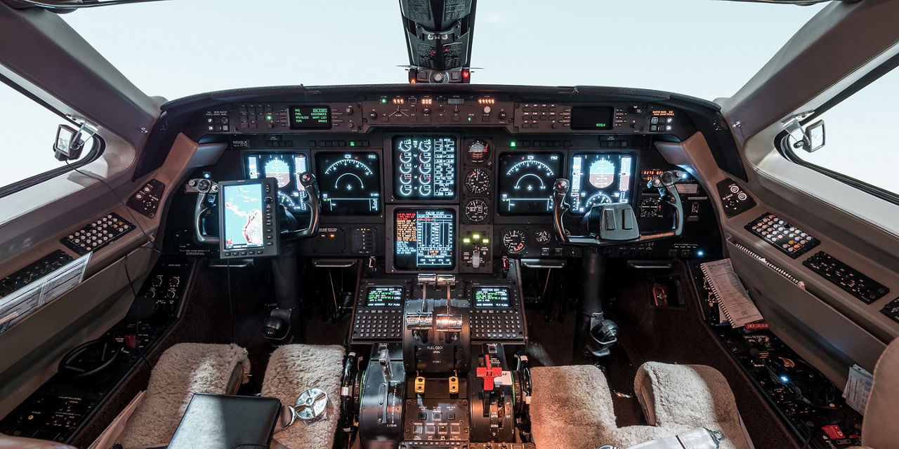 Detailed view of cockpit instrumentation including digital maps and flight data, illustrating high-end avionics and pilot interface.