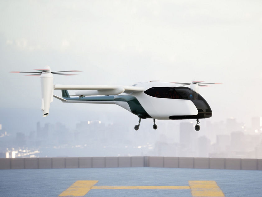 eVTOL vehicle hovering over a vertiport landing pad