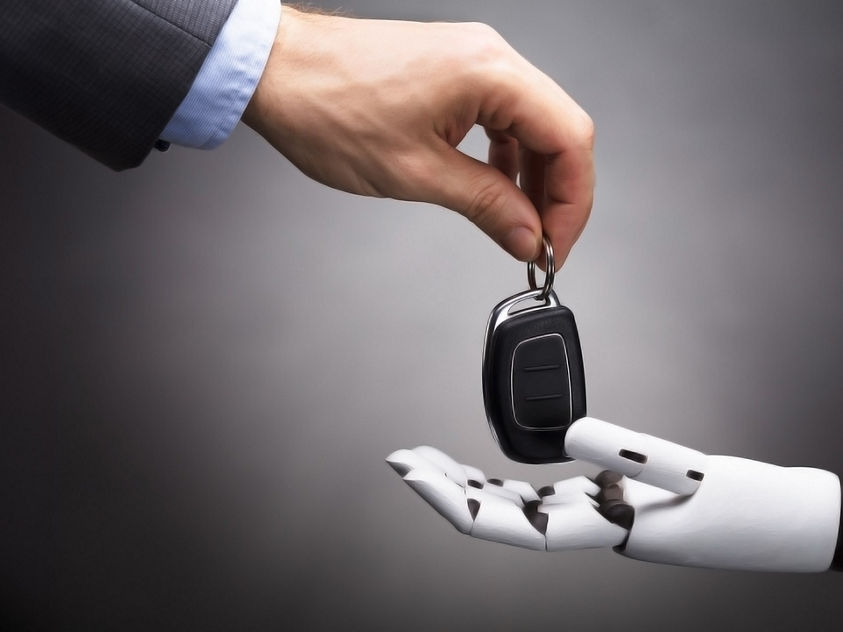 Human hand handing off keys to robot hand