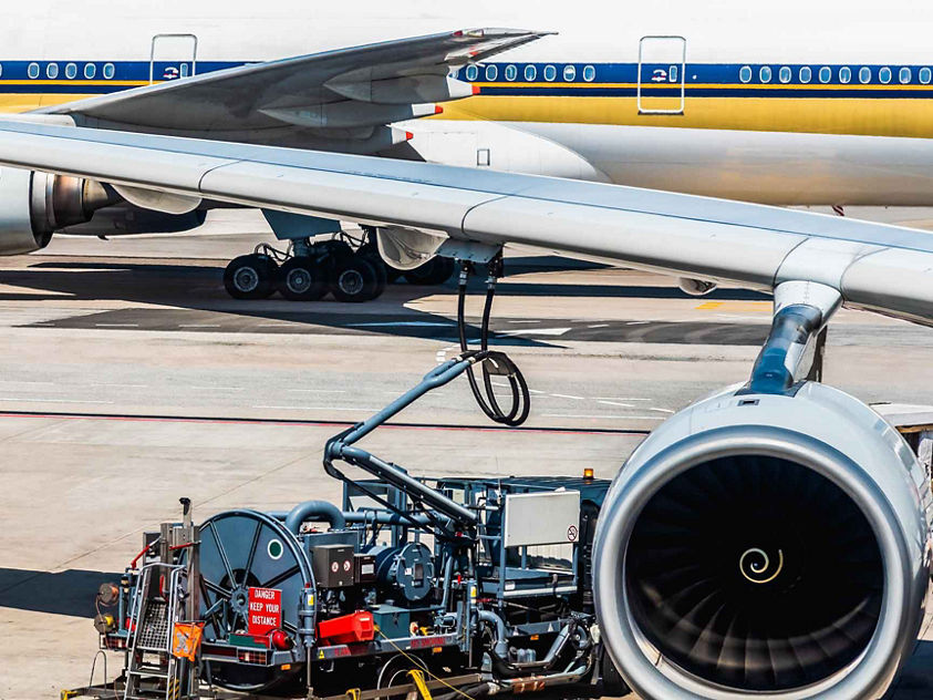 Refueling operation of passenger transport aircraft in the plane parked at the airport.