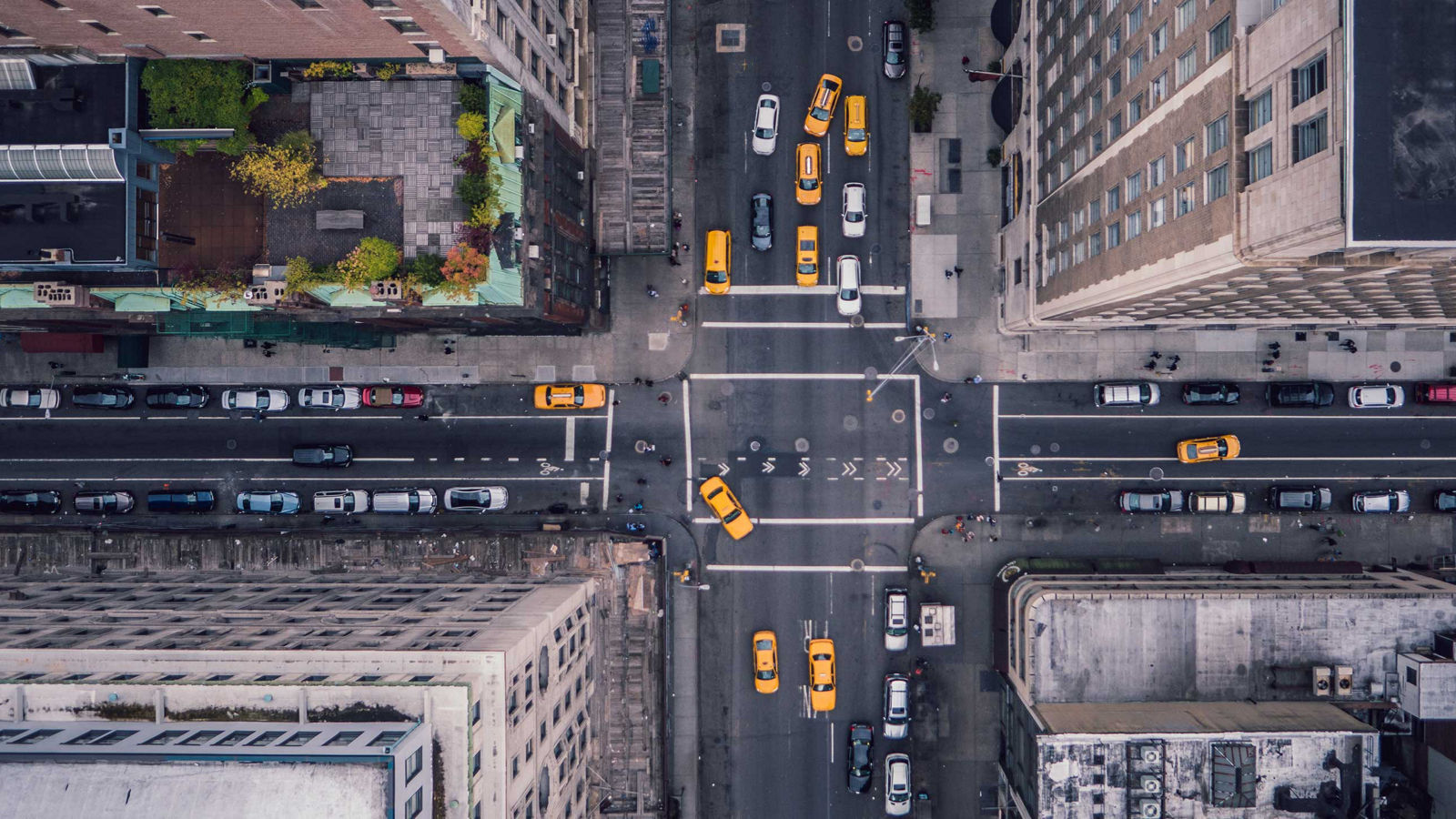 An aerial view of NYC streets with yellow cabs.