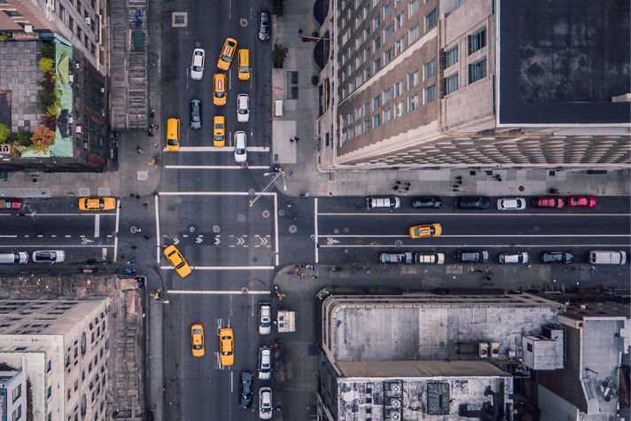 An aerial view of NYC streets with yellow cabs.
