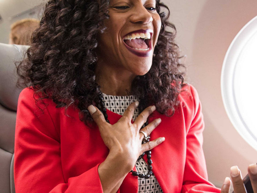 Woman Laughing at Phone