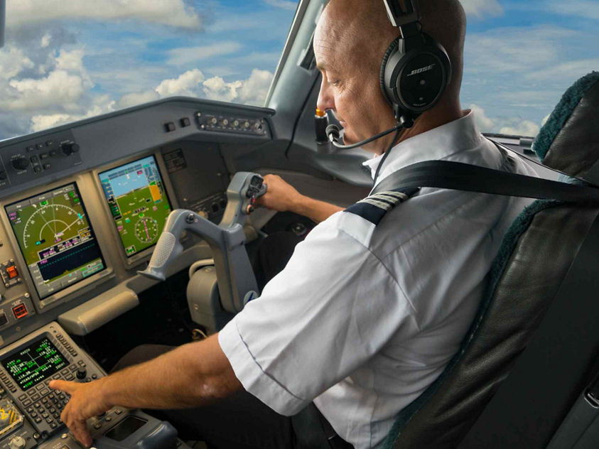 [Pilot With Tablet In Embraer 170 Cockpit Connectivity Deer Valley]
