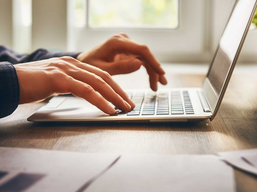 Typing at laptop