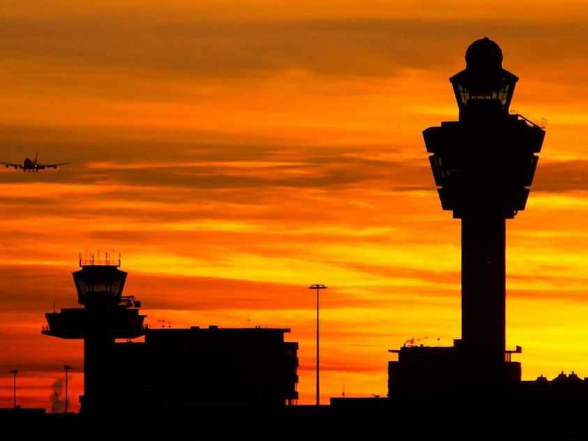 Air traffic control tower in front of sunset