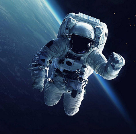 Astronaut floating in space above earth