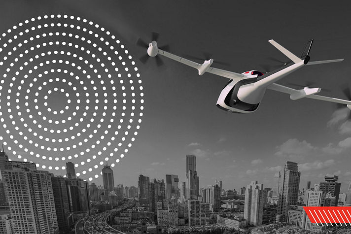 eVTOL aircraft flying toward a modern city skyline during daytime