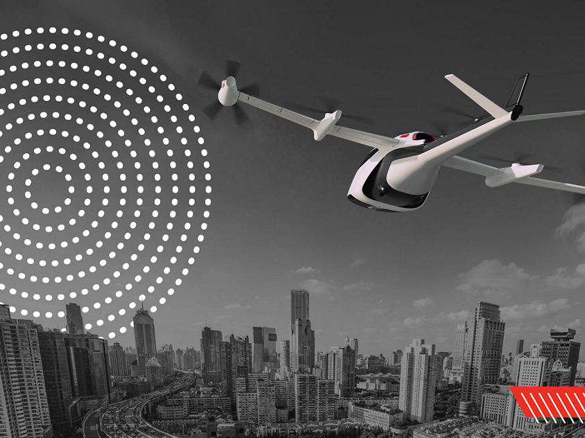 eVTOL aircraft flying toward a modern city skyline during daytime