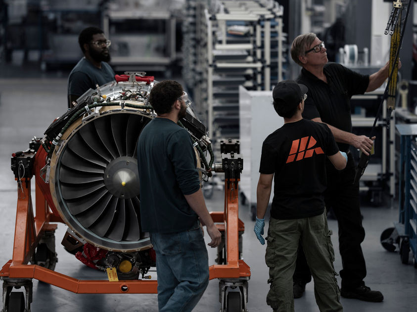 engineer with tablet in airplane hangar