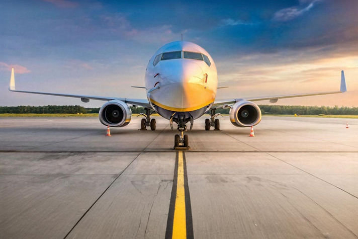 Commercial aircraft on the runway at sunrise, highlighting Honeywell Aerospace technologies that enhance operational awareness and mission effectiveness.
