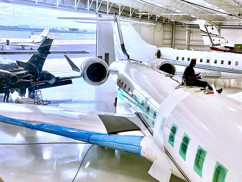  A spacious hangar containing multiple airplanes parked inside