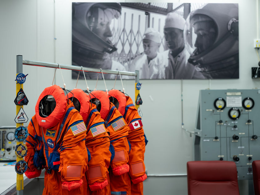  image displays four Orion Crew Survival System (OCSS) spacesuits prepared for the upcoming Artemis II moon mission