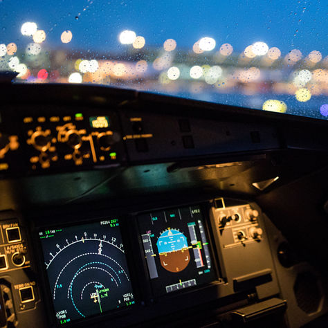 An aircraft cockpit featuring illuminated navigation screens and a pilot interface, emphasizing secure and precise flight operations.