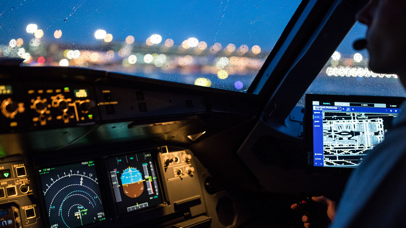 An aircraft cockpit featuring illuminated navigation screens and a pilot interface, emphasizing secure and precise flight operations.