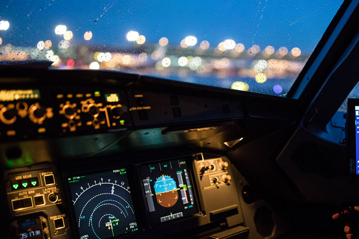 An aircraft cockpit featuring illuminated navigation screens and a pilot interface, emphasizing secure and precise flight operations.