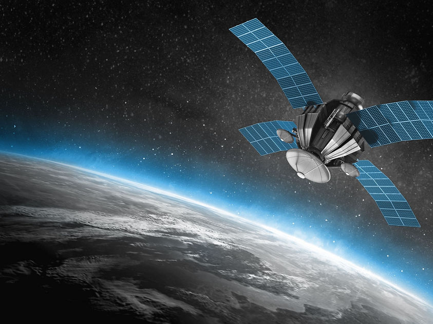 A satellite orbiting above Earth with visible land, clouds, and space background.