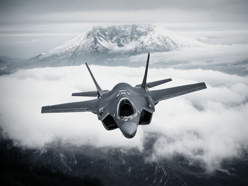 Lockheed Martin F-35 Lightning II, flying above cloud cover.
