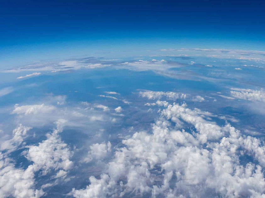 Stunning aerial view showcasing Earth's atmosphere, cloud formations, and the curvature of the planet.