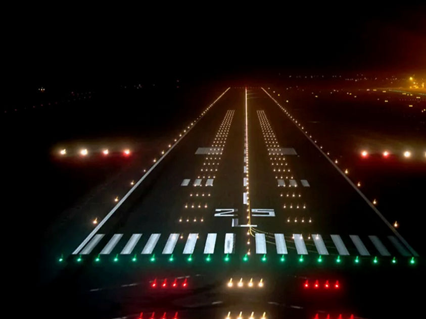 An airport runway at night, brightly lit, providing visibility for aircraft during takeoff and landing.