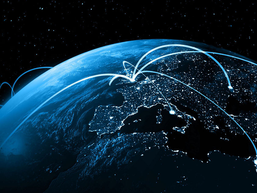 Earth illuminated by a network of lights, symbolizing global Satcom connectivity and communication technology.