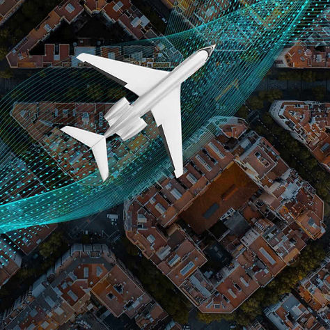 Aircraft flying over a city with buildings