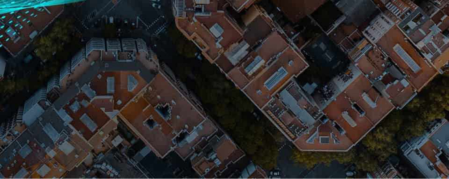 Aircraft flying over a city with buildings