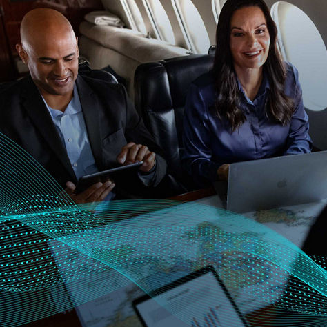 A group of professionals having a business meeting on a private jet.