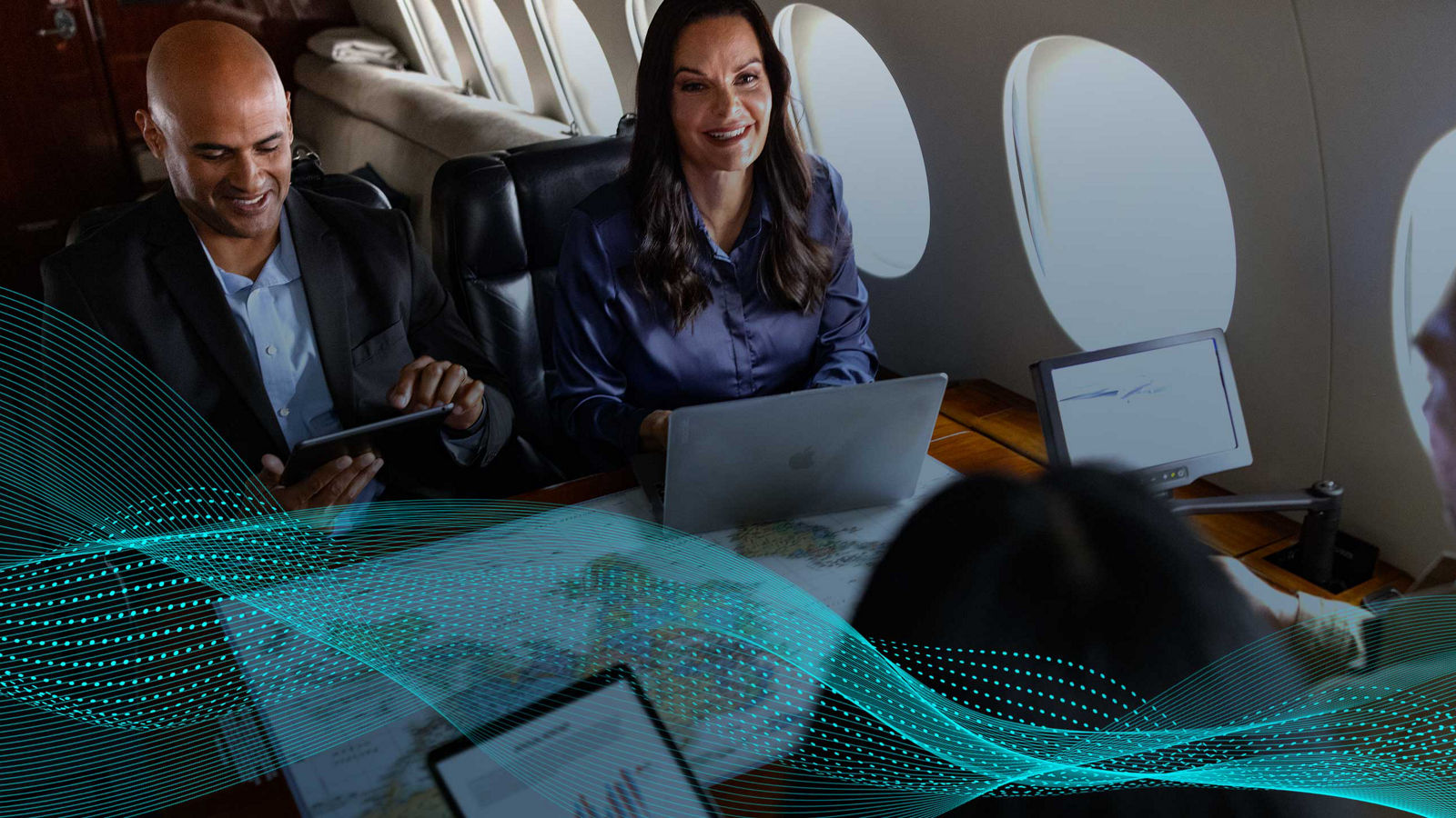 A group of professionals having a business meeting on a private jet.