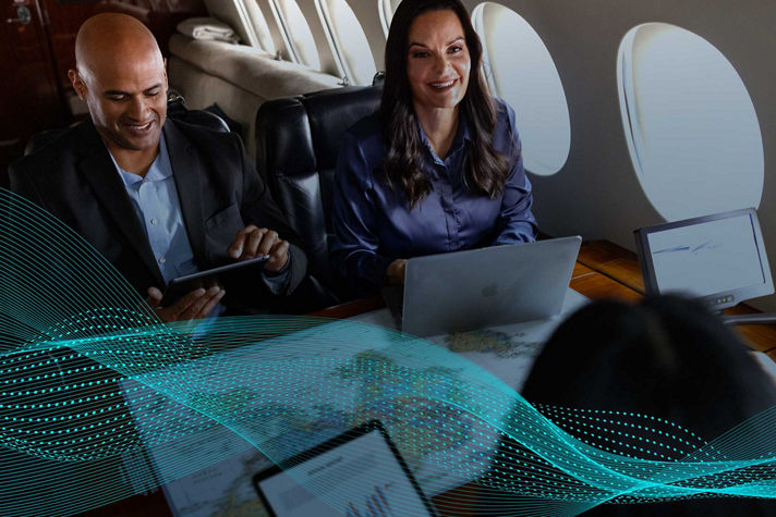A group of professionals having a business meeting on a private jet.