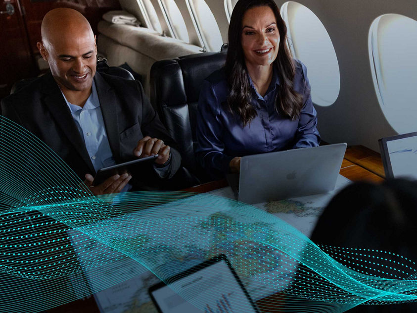 A group of professionals having a business meeting on a private jet.