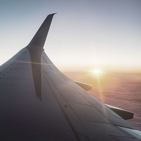 This image appears to show the view of a jet airliner wing during sunset