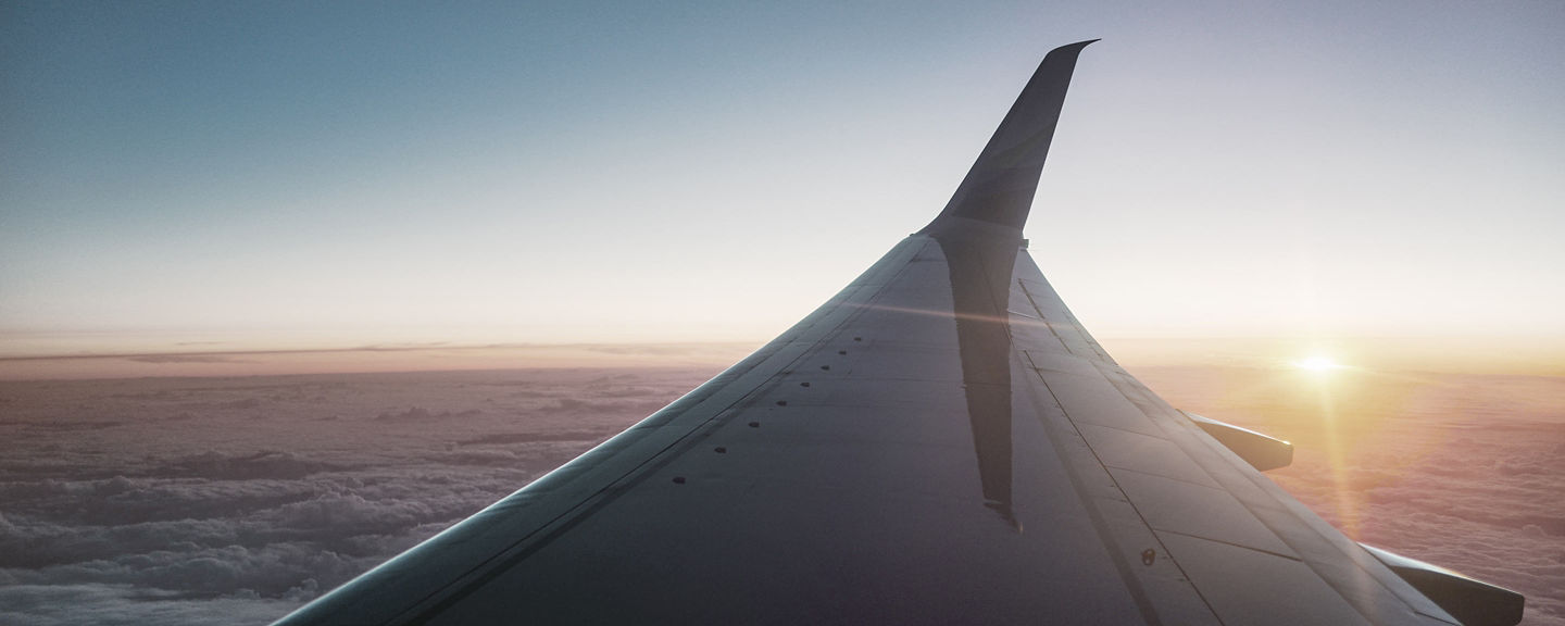 This image appears to show the view of a jet airliner wing during sunset