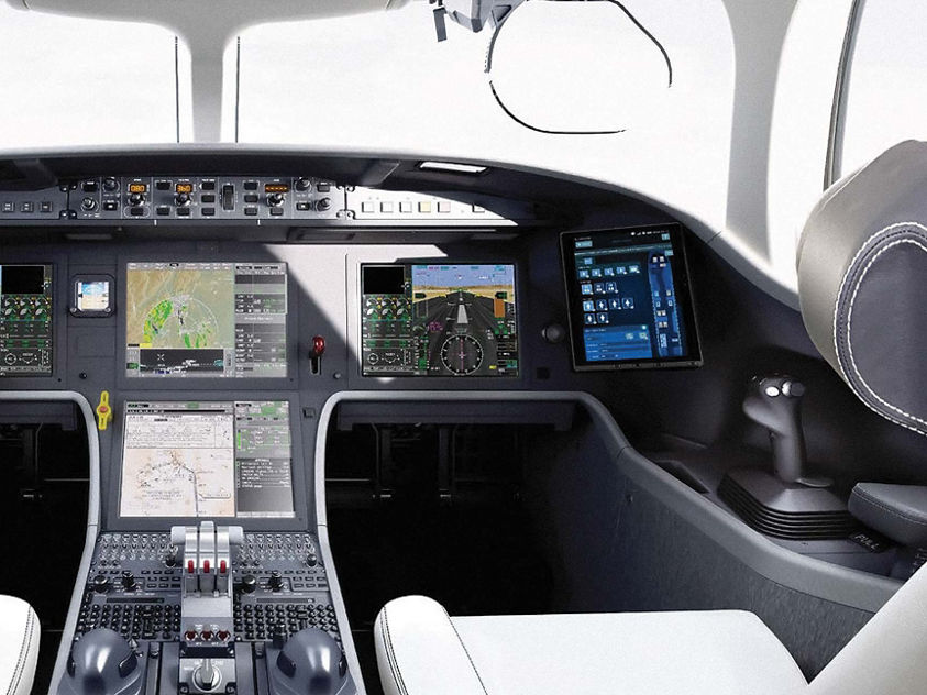 The cockpit of a private jet, with an engineer examining the controls and instruments