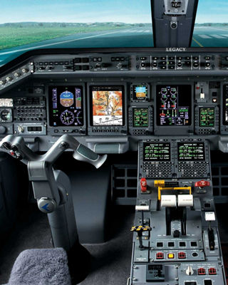 A pilot’s perspective from the cockpit, showcasing a serene green field stretching beyond the aircraft’s windshield under clear skies.