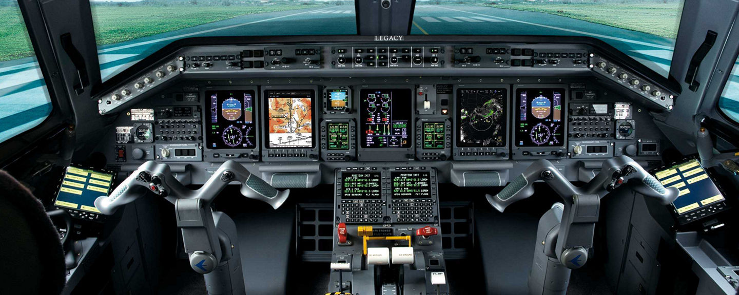 A pilot’s perspective from the cockpit, showcasing a serene green field stretching beyond the aircraft’s windshield under clear skies.