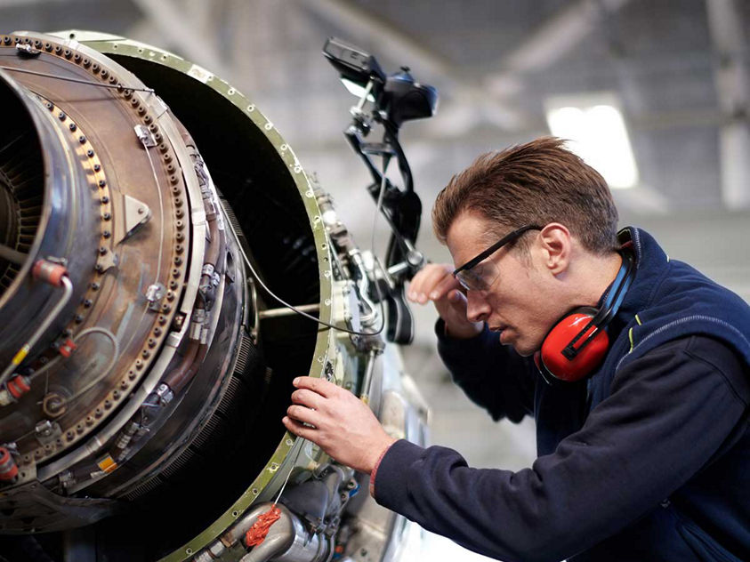 technician working on aircraft engine