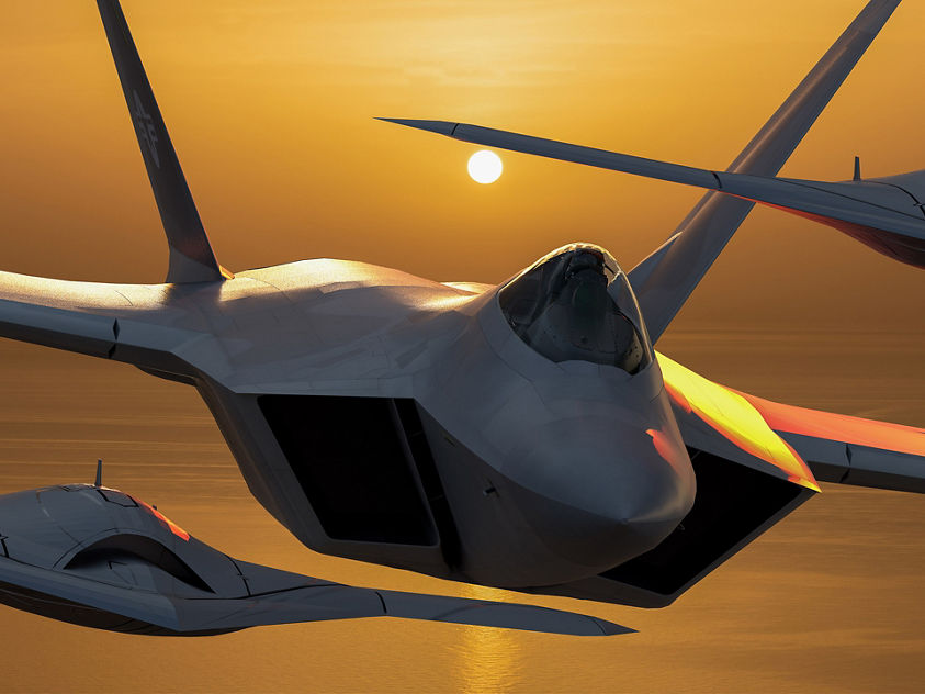 Trio of advanced jets silhouetted by golden horizon
