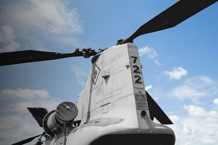 A Boeing Vertol CH-46 Sea Knight helicopter with a prominent top-mounted propeller, showcasing its military design.