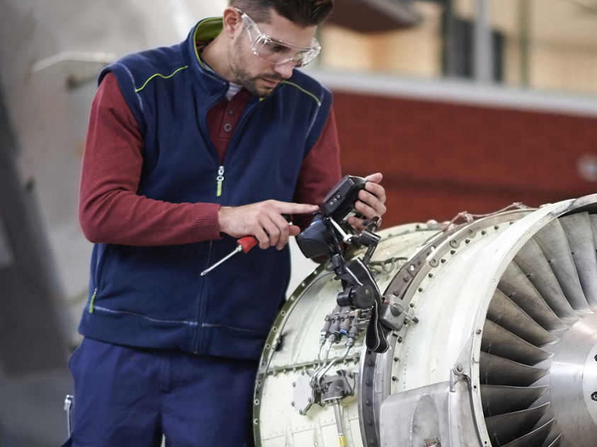 Engineer giving maintenance to an engine